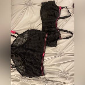 Black and hot pink sexy set. Bra and underwear with garter straps.